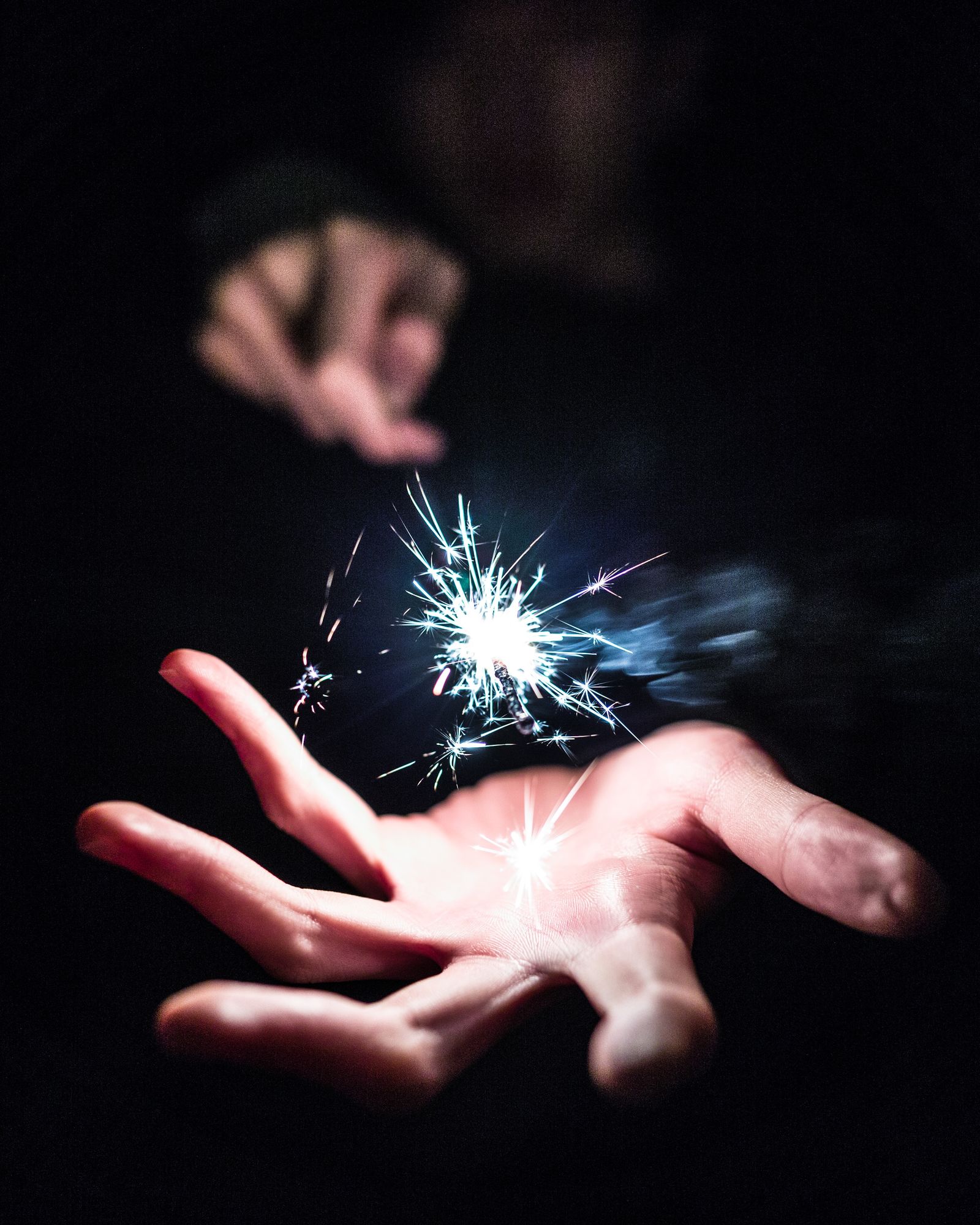 A hand holding a sparkler (illustrative image)