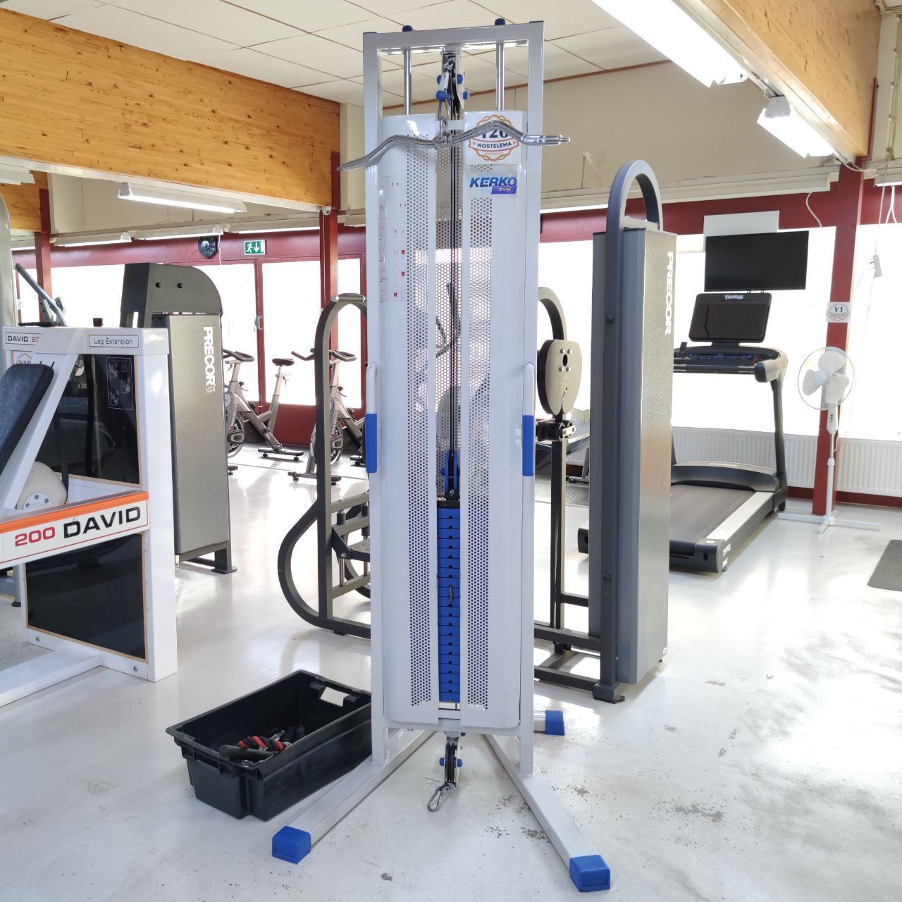 Kerko high/low pulley machine with an overhead bar and a weight stack in an upright column