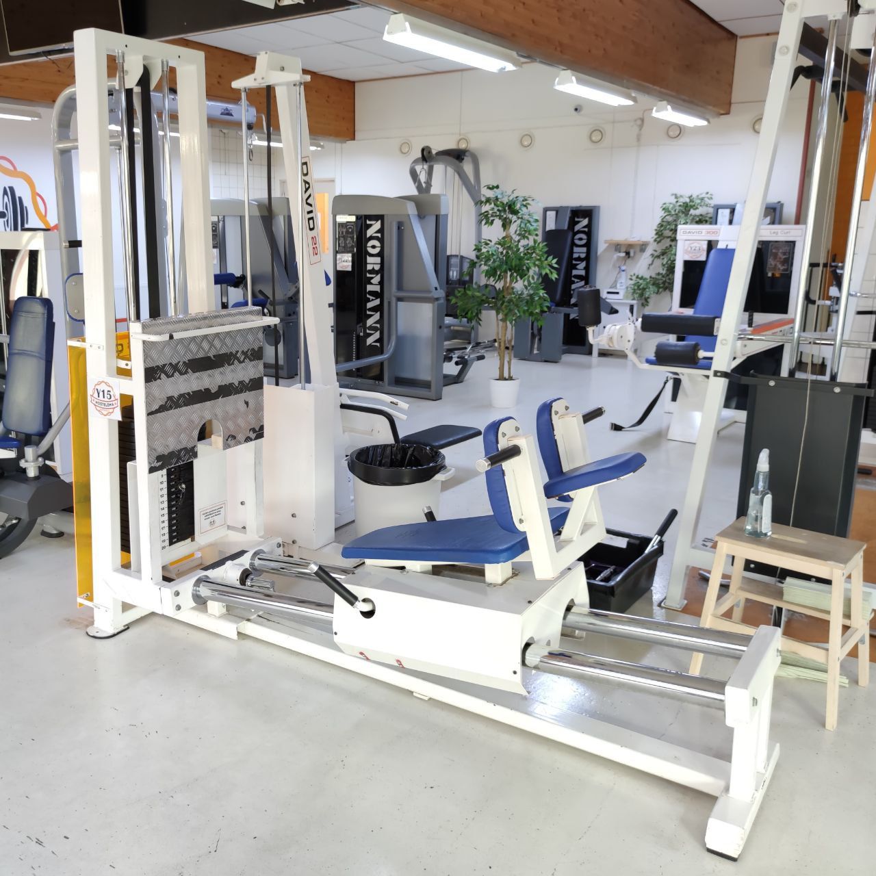 White David machine with a seat on horizontal rails and a weight stack