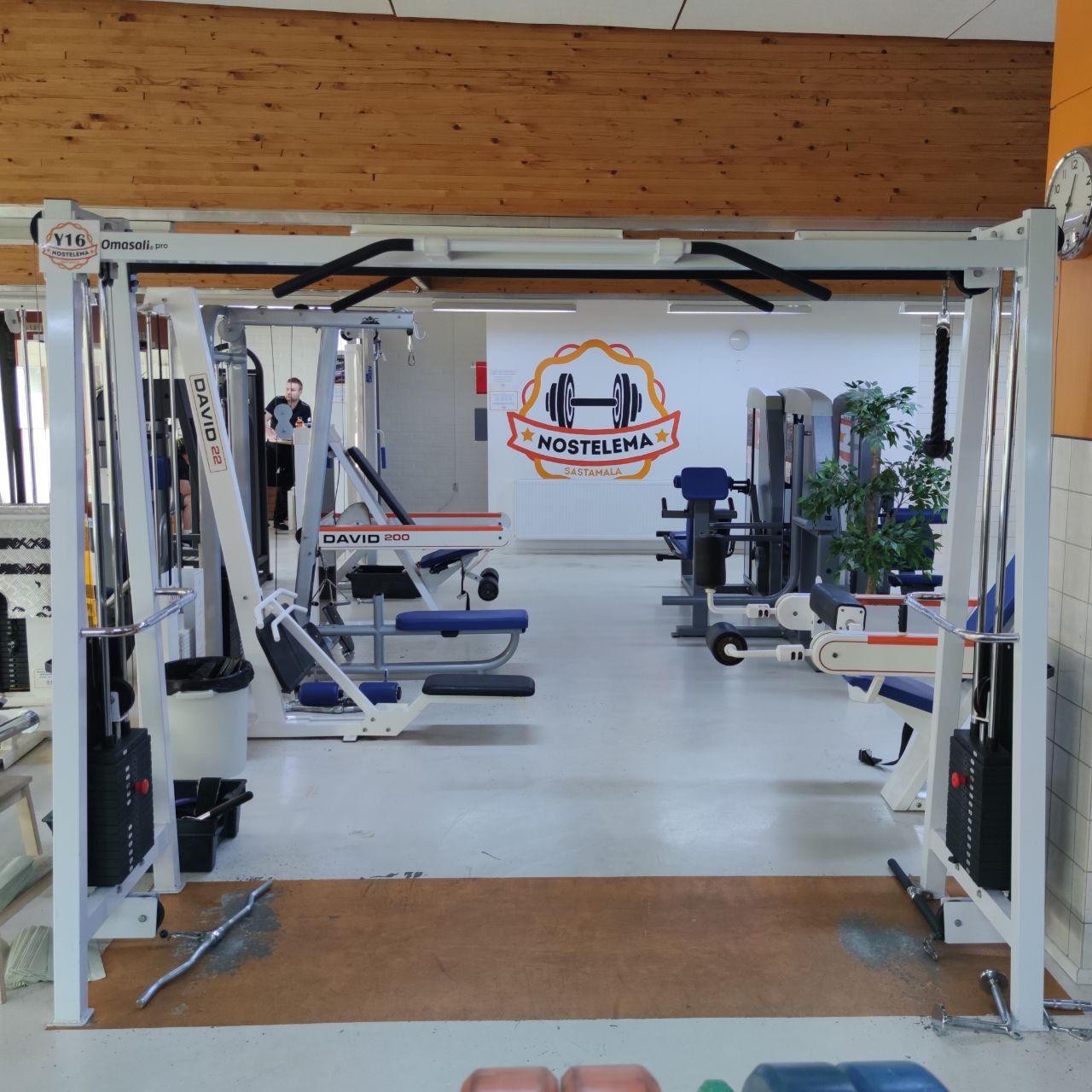 Cable crossover with two weight stacks and a pull-up bar above