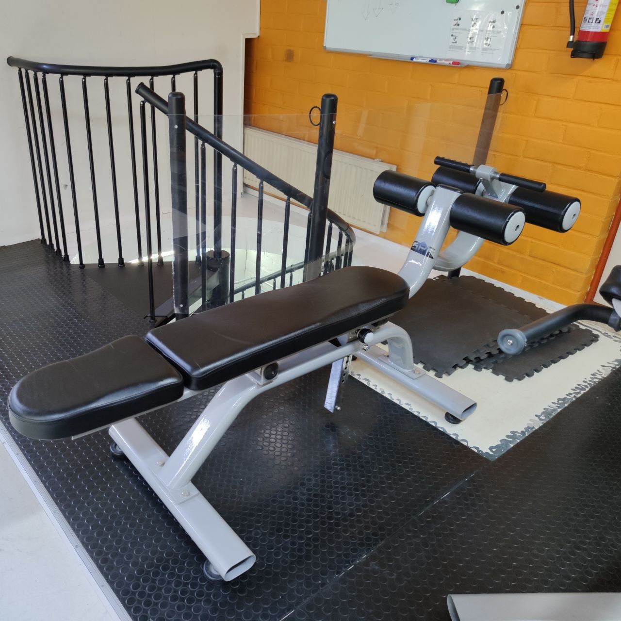 Adjustable ab bench with ankle supports at the end