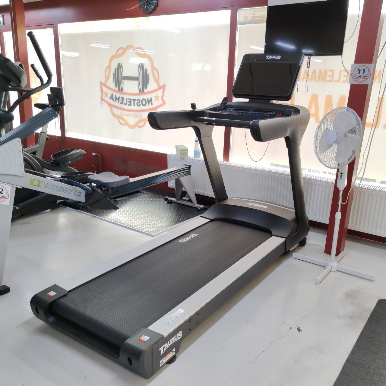 Treadmill and a television in Nostelema’s cardio area