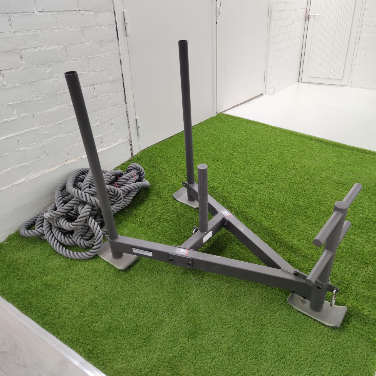 Weight sled (prowler) and battle rope in Nostelema’s functional training area