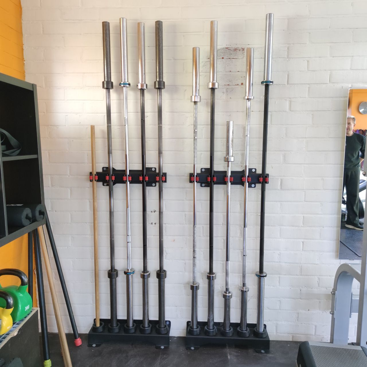 Barbells in a wall rack at Nostelema